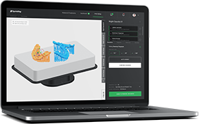 The image shows a laptop displaying a 3D modeling software interface with a partially rendered 3D model of a product, which appears to be a food item, possibly a pastry or dessert, with a view from above and below, placed on a platform with measurement tools visible around it. The laptop is open, and the screen is clearly visible, displaying the software interface with various options and toolbars.
